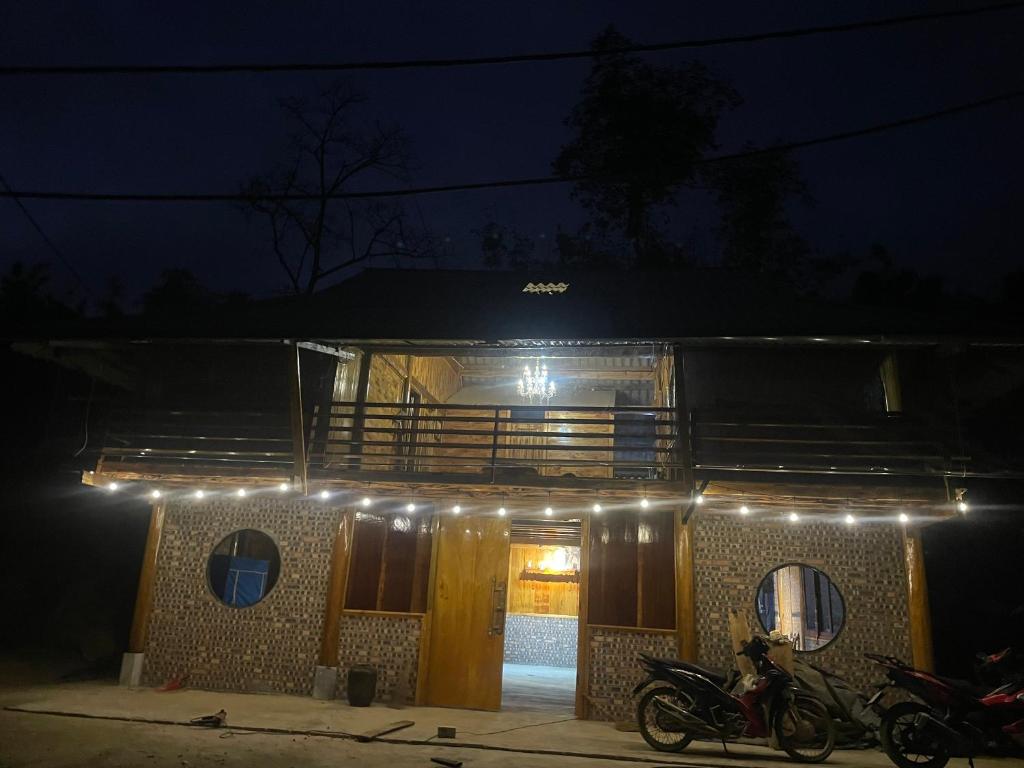 a house with a motorcycle parked in front of it at night at Friendly Homestay & Authentic Trekking Tours in Sapa