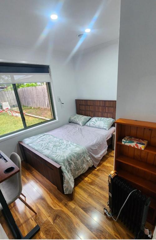 a bedroom with a bed and a large window at Private Room with a view, close to everything in Sydenham
