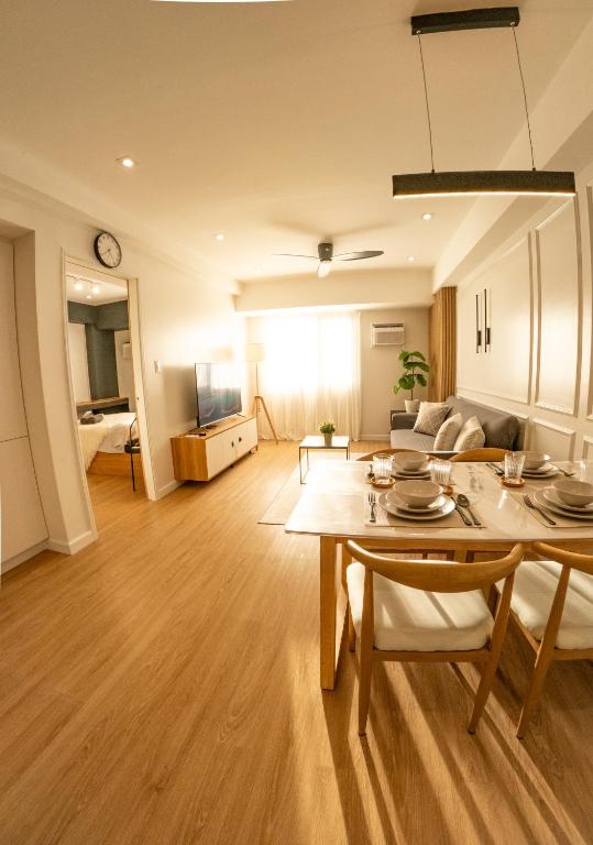 a living room with a table and a couch at The Cabin Tagaytay City by John Morales in Tagaytay