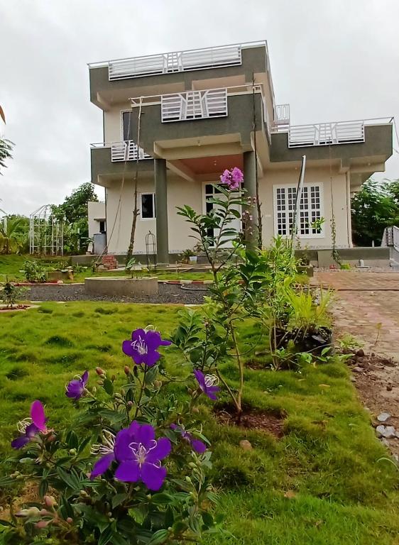 a house with purple flowers in front of it at 'Tatvamasi' Farmstay, Hillock The Nature Retreat, Vikarabad in Morangpalli