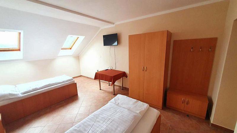 a bedroom with two beds and a desk in it at Penzion rodina in Chornice