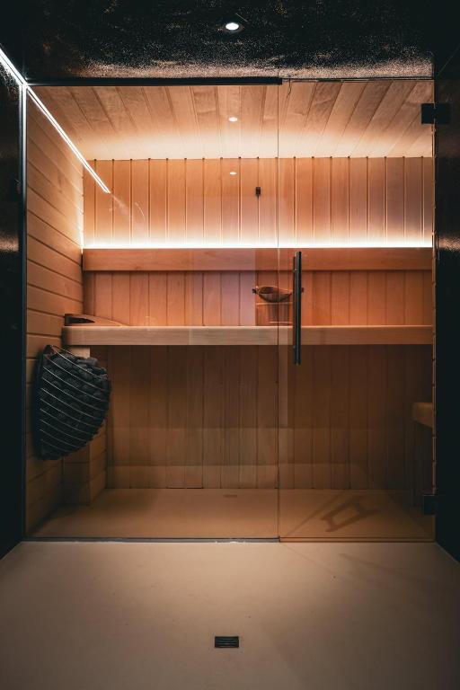 ein Glasschrank im Badezimmer mit einem Regal in der Unterkunft La Forge in Wanze