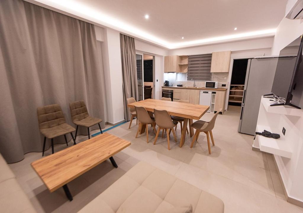 a kitchen and dining room with a wooden table and chairs at Sinani Villas Rhodes in Afantou