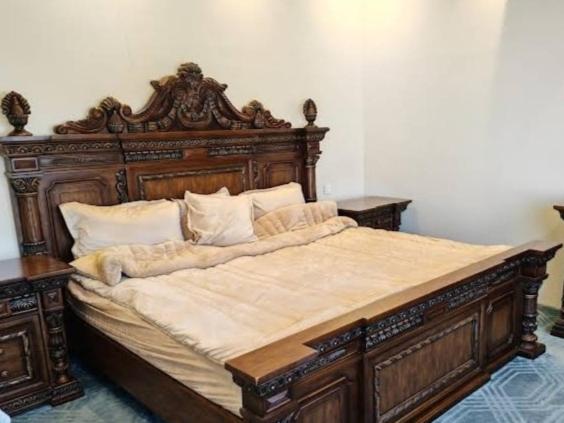 布赖代شالية نخلة的卧室内的一张带木框的大床