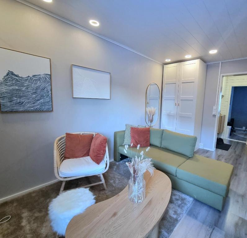 a living room with a couch and a table at Coastal Guest House in Rauma