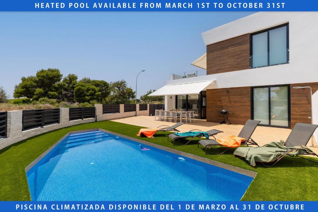 a house with a swimming pool in front of it at Luxurious & Comfy by Fidalsa in Carrer del Mar