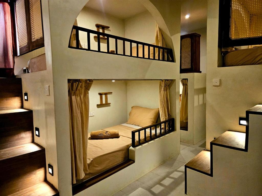 a small room with a bed in a building at Casa Carmen Hostel in Weligama