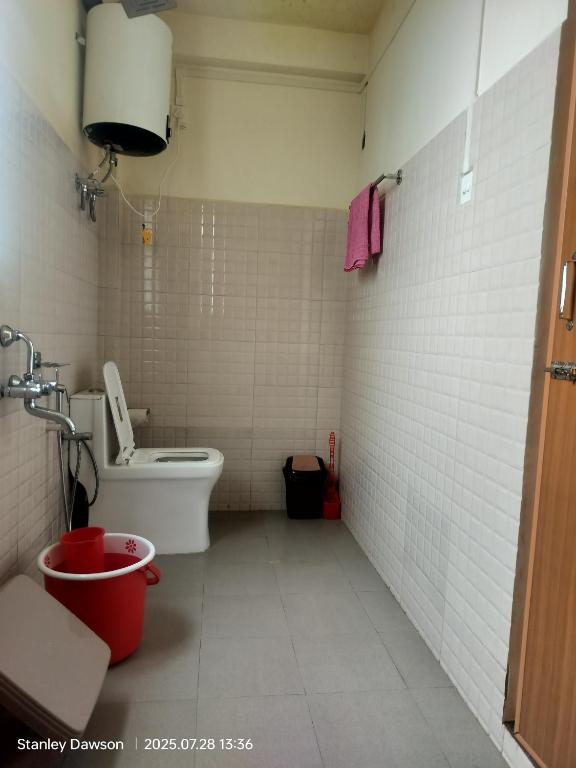 a small bathroom with a toilet and a sink at Adoreen Homestay in Cherrapunji