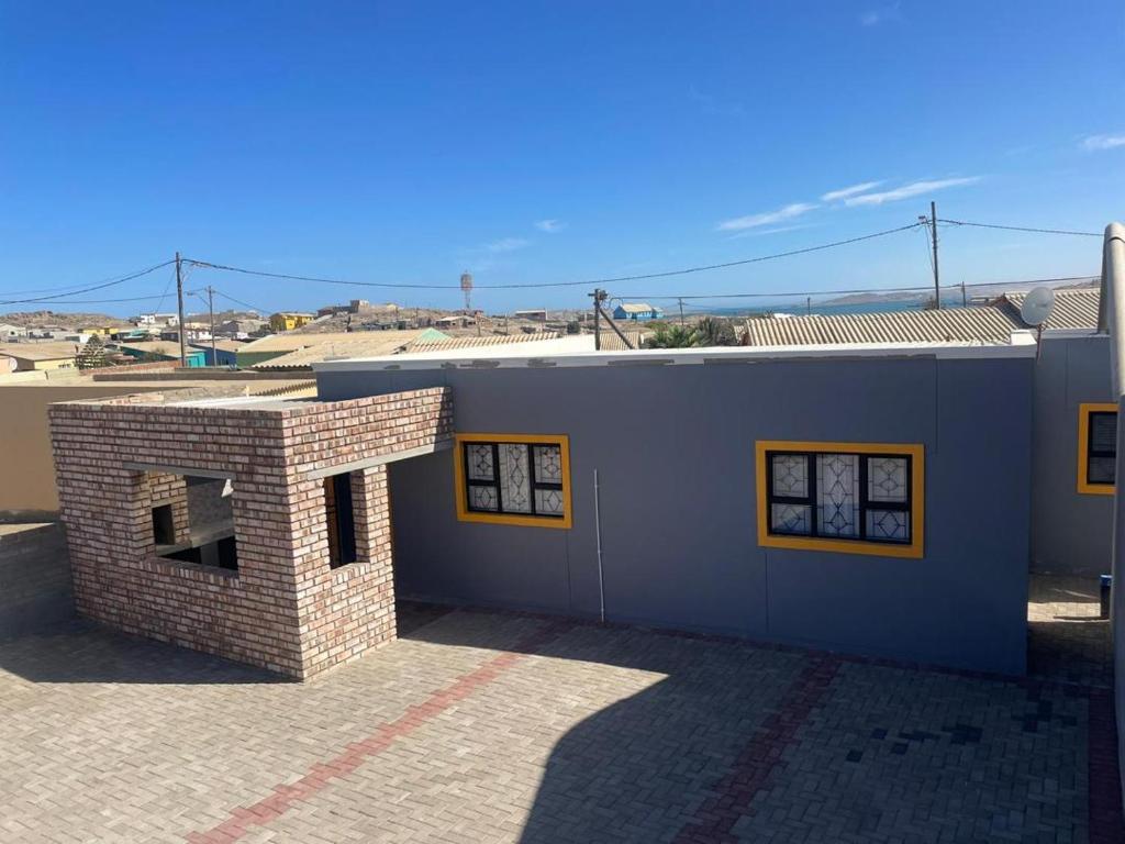 a building with a brick chimney on the side of it at Eighth Avenue Self Catering Accommodation in Lüderitz