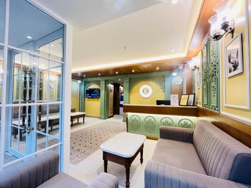 a lobby with a couch and a table at Elegance Inn in Varanasi
