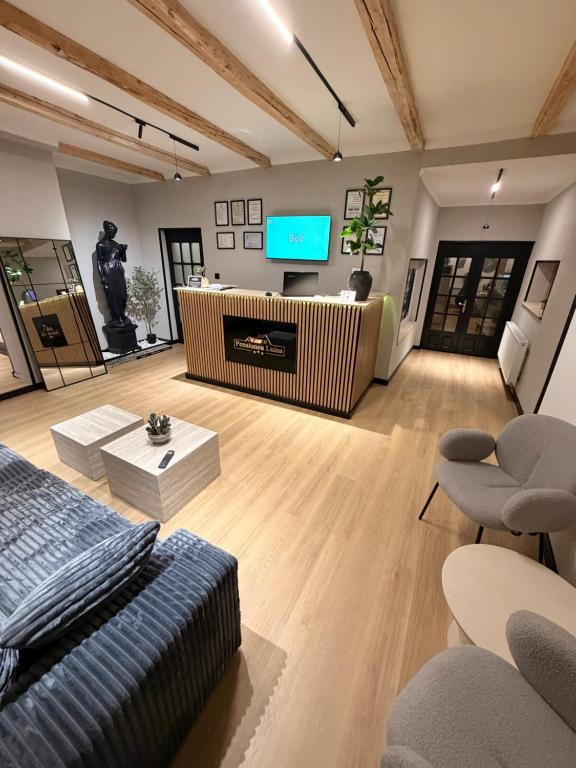 a living room with a couch and a flat screen tv at Pensiunea Luisa in Craiova