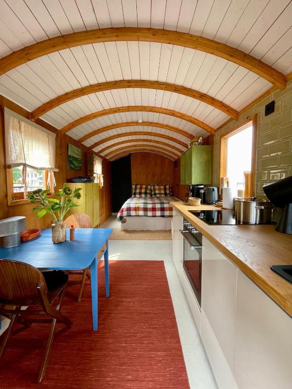 a kitchen with a blue table in a room at Tuiny House Noordwijk in Noordwijk