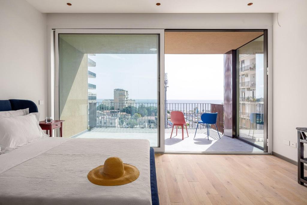 a bedroom with a bed with a hat on it at Rotolo Roof 21 5C in Catania