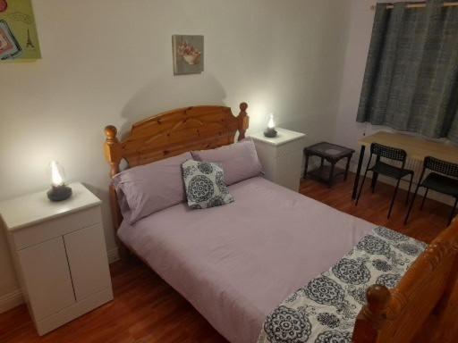 a bedroom with a bed with two pillows on it at Double room beside tramline in Dublin