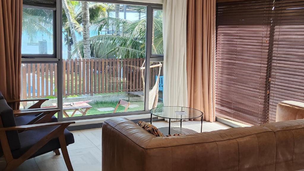 a living room with a couch and a glass table at Beach House at Kokrobite in Kokrobite
