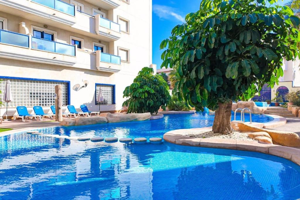 a swimming pool in front of a building at Playamarina 1 Reception in Cabo Roig