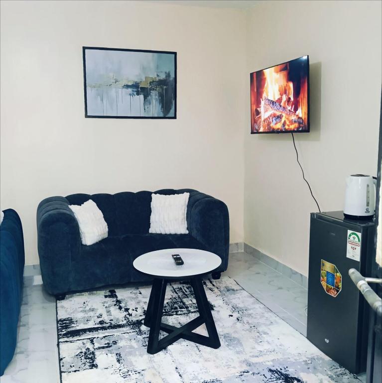 a living room with a couch and a table at AA Suites 87 in Nairobi