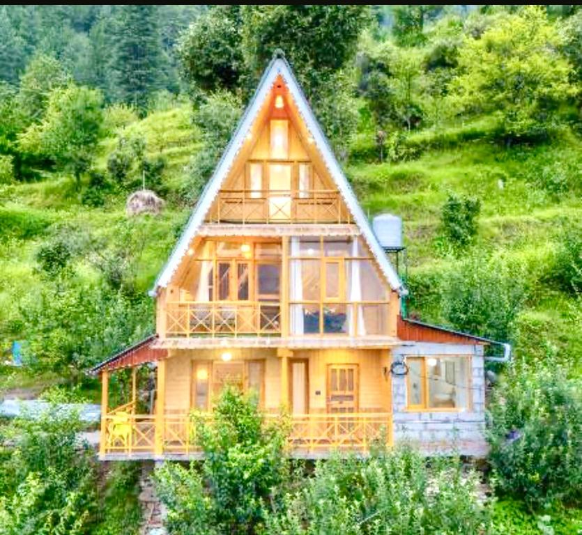 a large wooden house on top of a hill at The nature view A shape tree cottage in Banjār