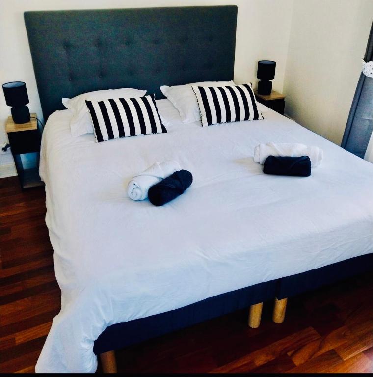 a large white bed with two stuffed animals on it at Ty Kéréon - Le cocon urbain in Quimper