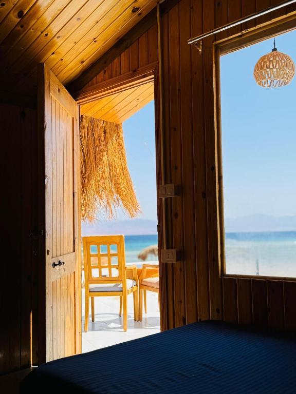 a bedroom with a bed and a view of the ocean at palma beach camp nuwibae in Nuweiba