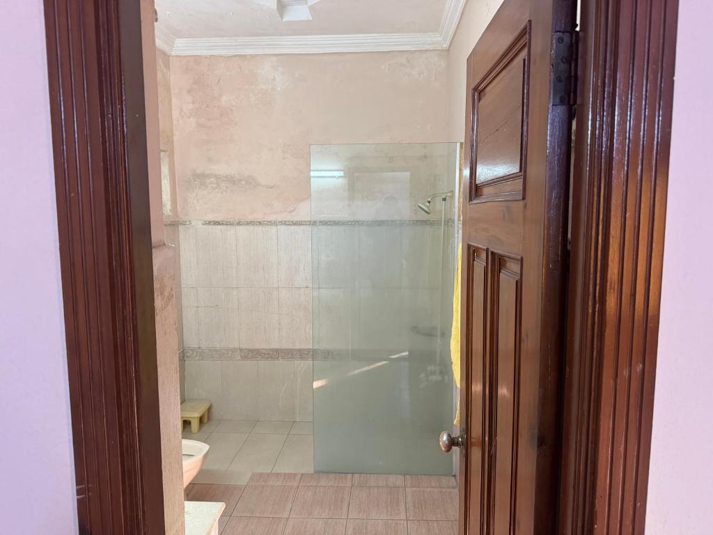 a bathroom with a glass shower with a toilet at Musa house D ground in Faisalabad