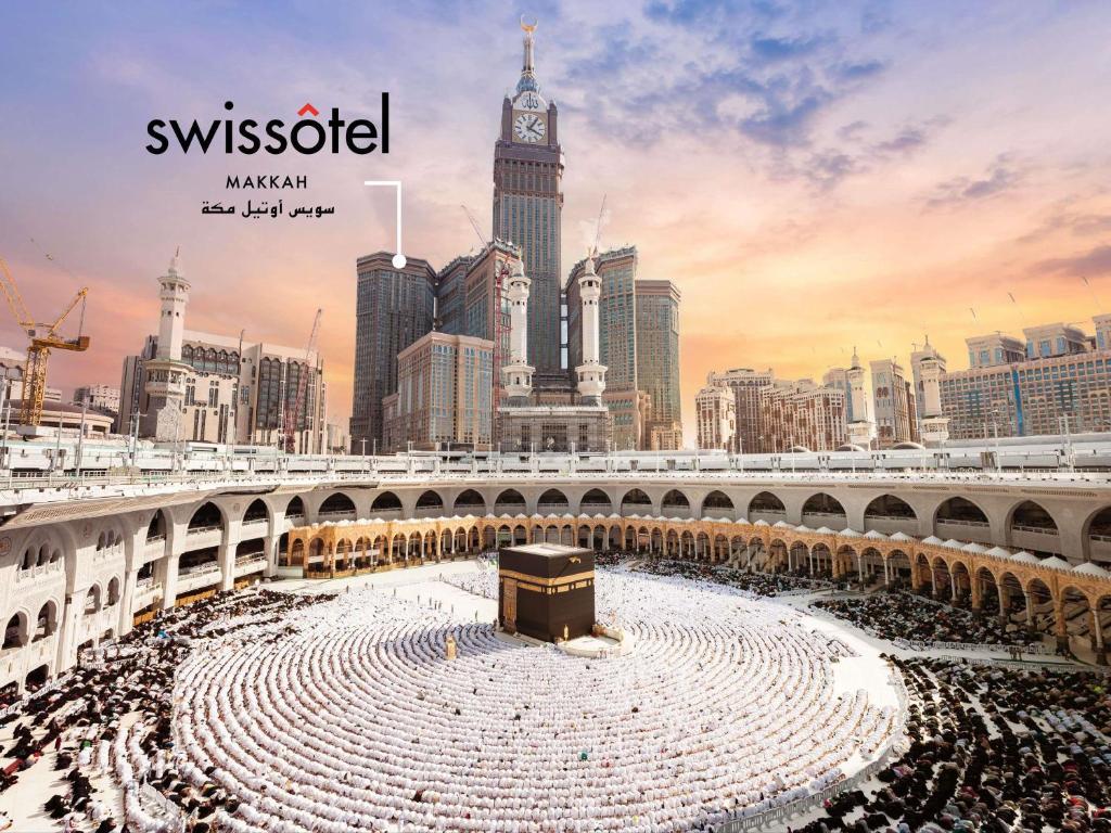 a large crowd of people in a city with a clock tower at Swissotel Makkah in Makkah