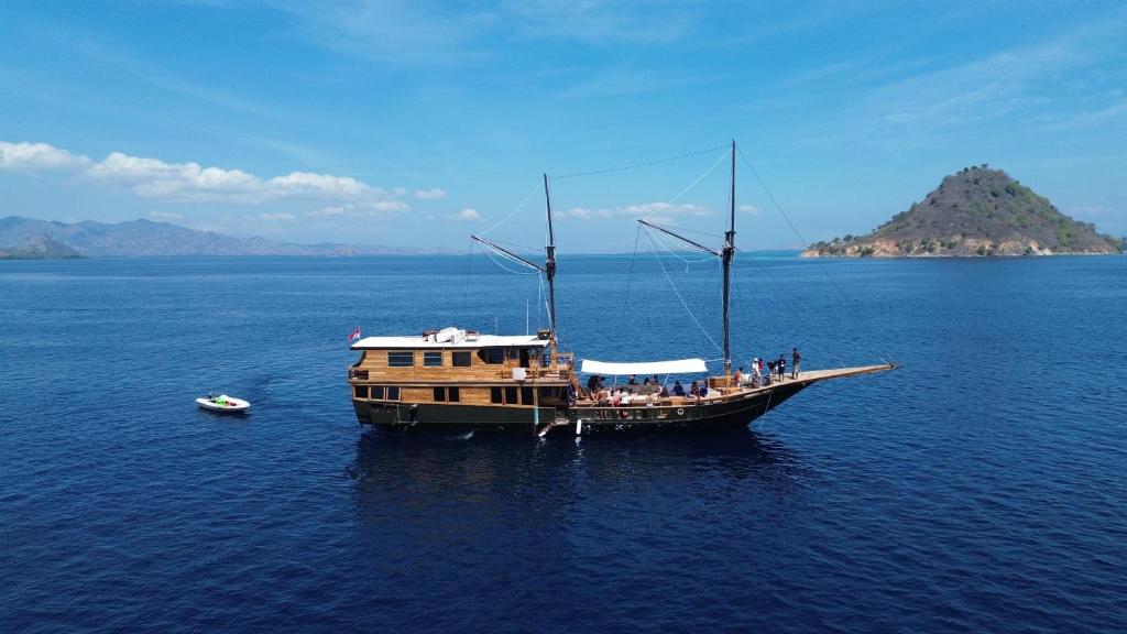 a boat in the middle of a large body of water at Shared Boat Komodo 3 days 2 Night in Komodo Labuan Bajo Airport