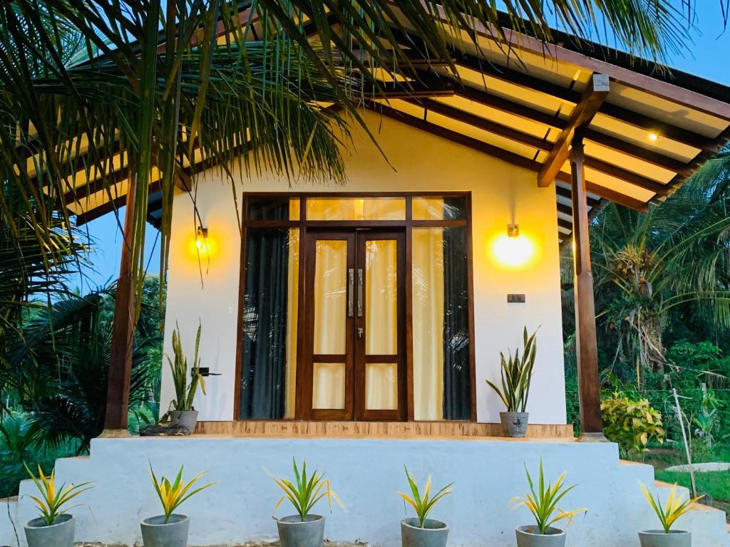 a house with a front entrance with plants in front at water lily heaven in Tangalle