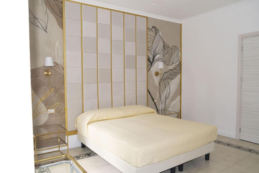 a room with a bed and a tiled wall at Dimora delle Storie in Tempio Pausania