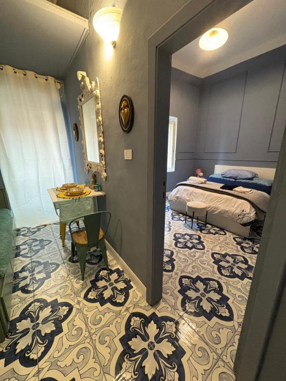 a bedroom with a bed and a table and a bed sidx sidx sidx at Palazzo Rubina - Dimora mediterranea & SPA in Torre del Greco