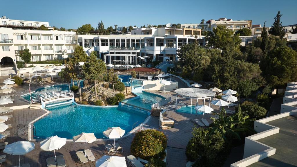 an aerial view of a resort pool with umbrellas at Kiotari Miraluna Beach Resort in Kiotari