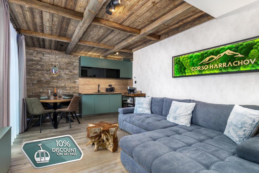 a living room with a couch and a table at Mountain Apartment No 209-CORSO Harrachov, High Speed WI-FI, Ambilight smart TV, Netflix, YouTube, FREE parking, PRIVATE ski storage, "Ski-in Ski-out", HARRACHOVCARD in Harrachov