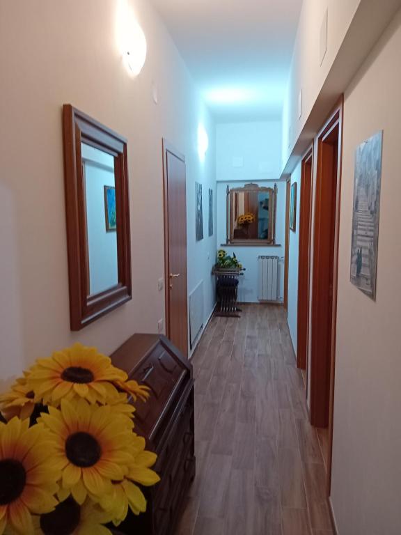 a hallway with a vase of sunflowers in a room at La Casa di Rossella in Scanno
