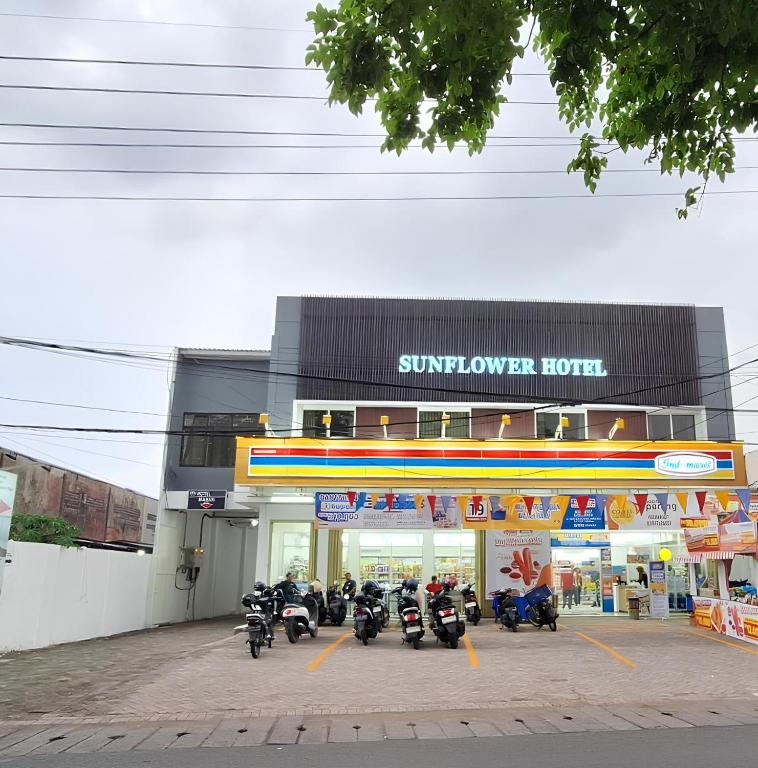 a group of motorcycles parked in front of a sunflower hotel at Sunflower Hotel Syariah near Juanda Airport in Dares