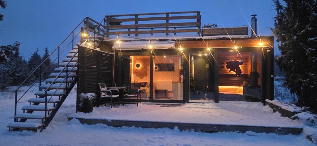 a cabin in the snow with a staircase leading to it at 2me2 - getaway in Värati in Värati