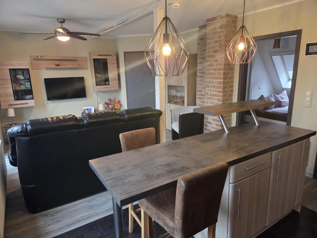 a living room with a table and a couch at Ferienwohnung Salza in Nordhausen