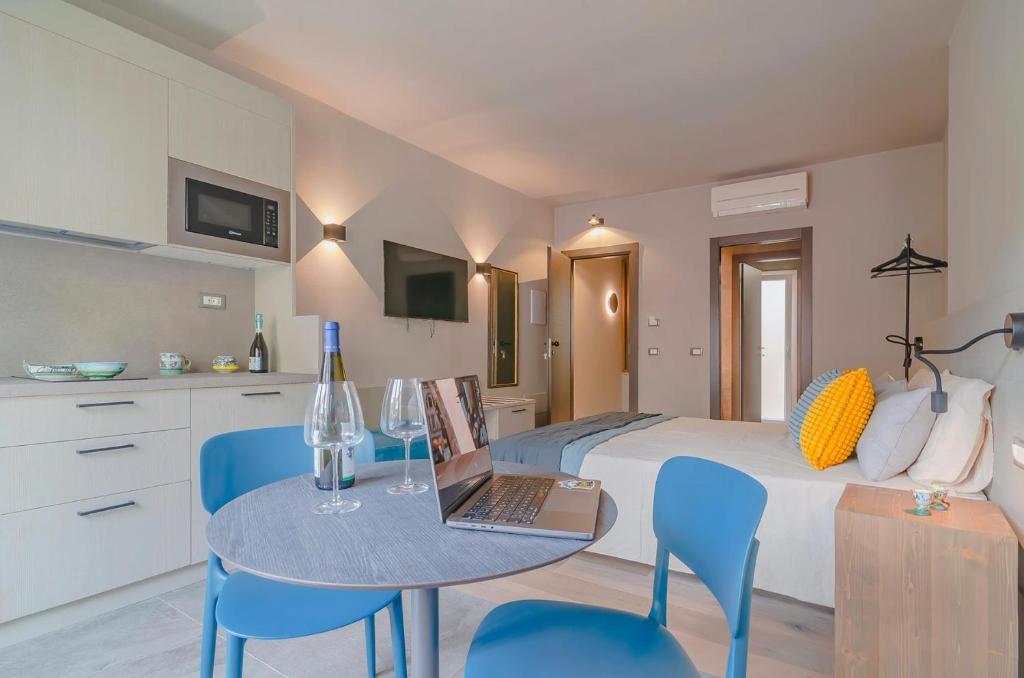 a bedroom with a bed and a table with a laptop at Ca' De Carme' in Riomaggiore