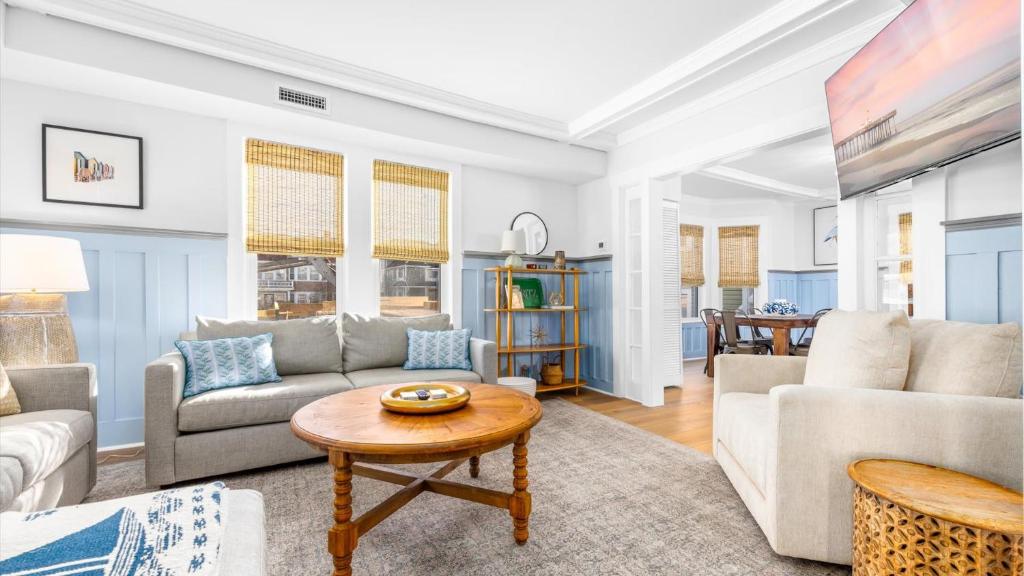 a living room with a couch and a table at 5BR plus Den - Downtown OC - Sleeps 16 in Ocean City