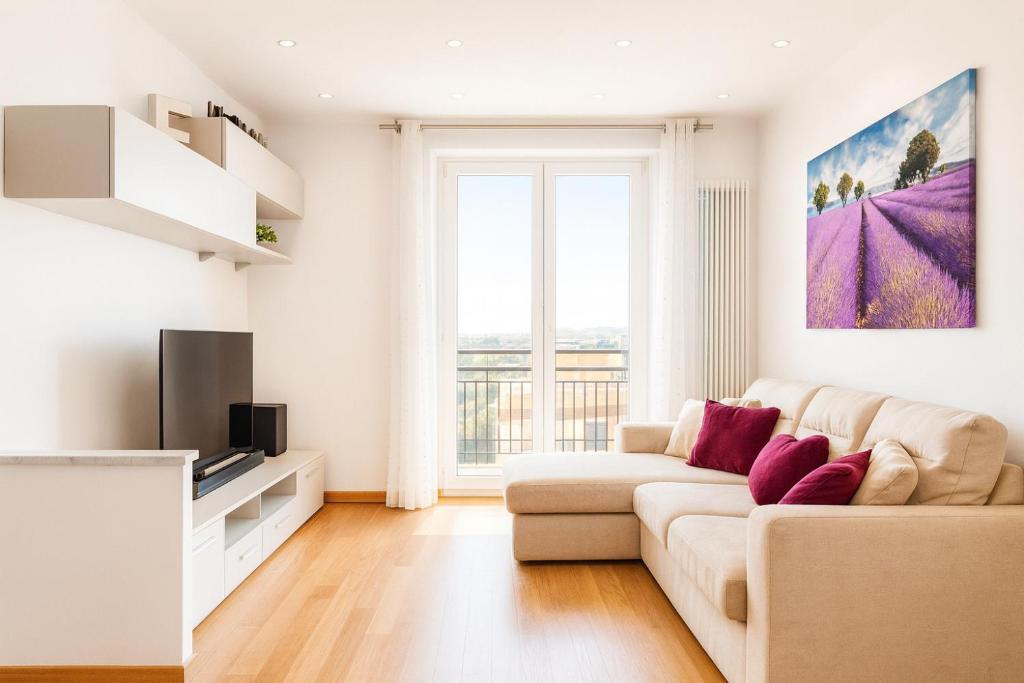 ein weißes Wohnzimmer mit einem Sofa und einem TV in der Unterkunft Frank's Sunset in Genua