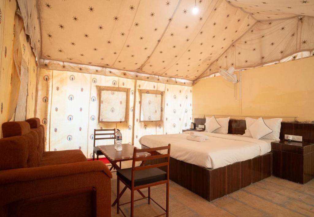 a bedroom with a bed in a tent at Raj Kesari Heritage Camp in Jaisalmer