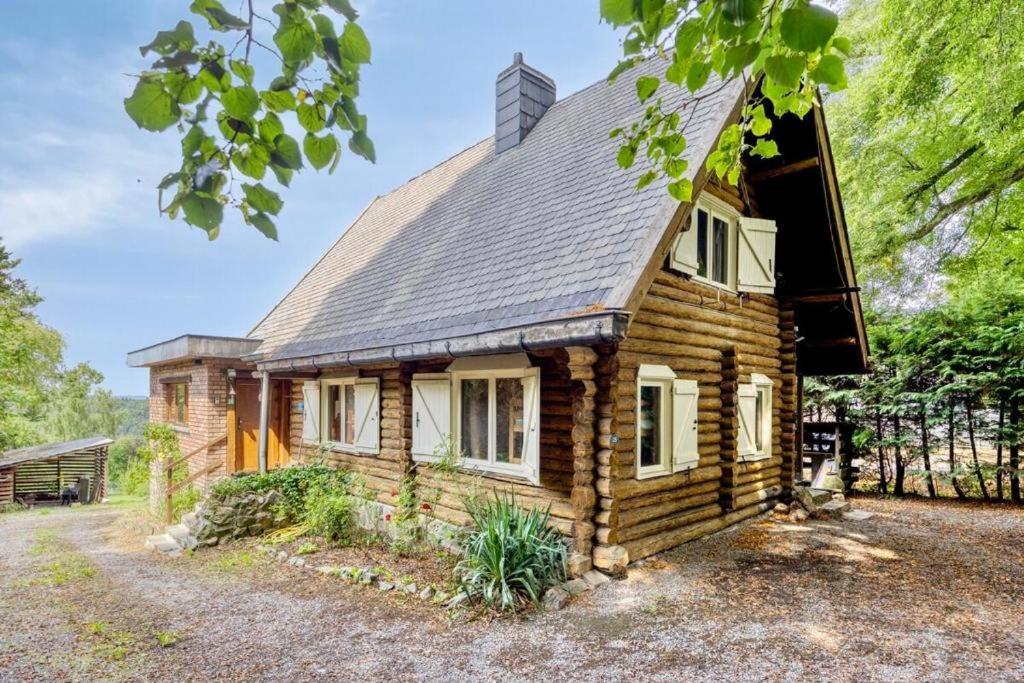 a log cabin with a metal roof at Le Chalet Rustique in Spa