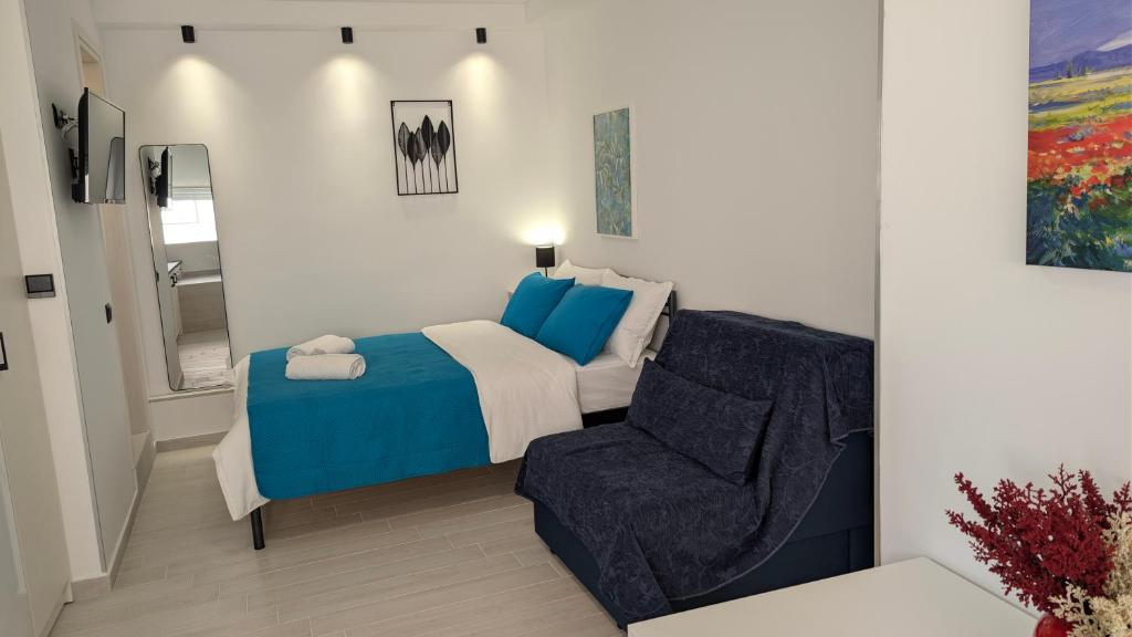 a small bedroom with a bed and a chair at Christina's Studio in Kalabaka