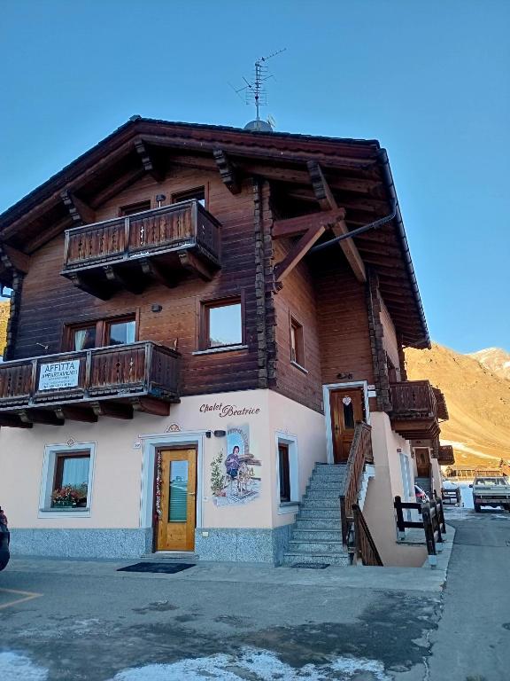 a log building with stairs and balconies on it at Chalet Beatrice in Livigno