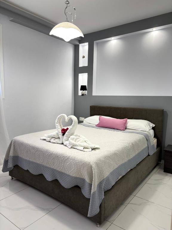 a bedroom with a bed with two swans on it at Panorama Apartments in Prinos