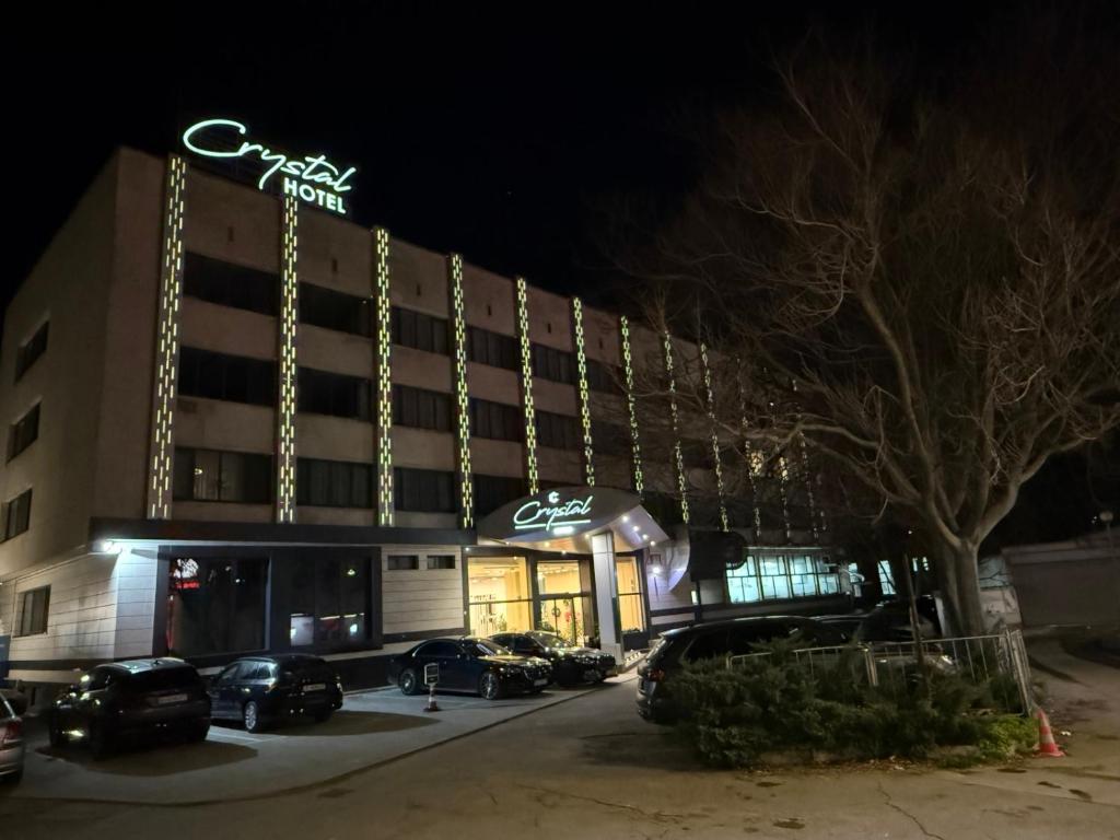 a hotel with cars parked outside of it at night at Хотел Crystal in Ruse