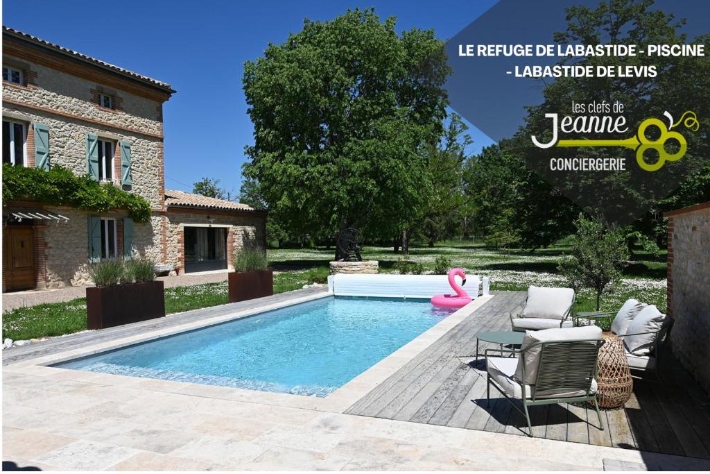 a swimming pool in front of a house at Le Refuge de Labastide - Charme & Sérénité in Labastide-de-Lévis
