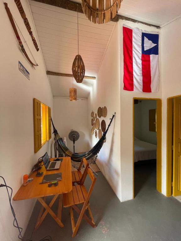 a room with a hammock and an american flag at CARAÍVA House in Caraíva