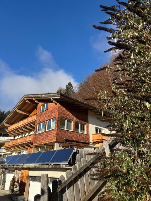 a house with a christmas tree in front of it at Ferienwohnung Mayrhofer in Leogang
