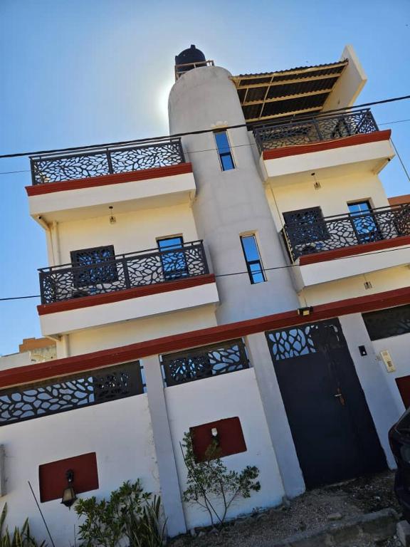a building with a lighthouse on top of it at Sunset Senegal in Rufisque