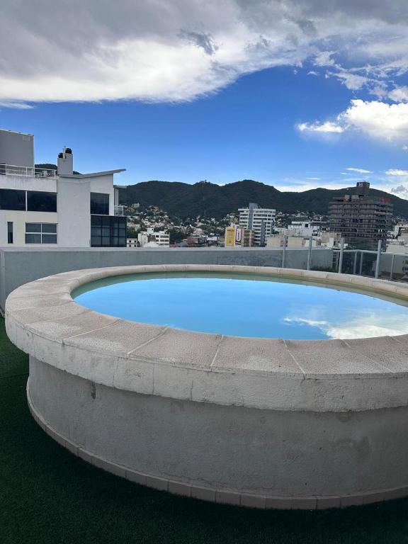 a large swimming pool on top of a building at Depto centro in Villa Carlos Paz